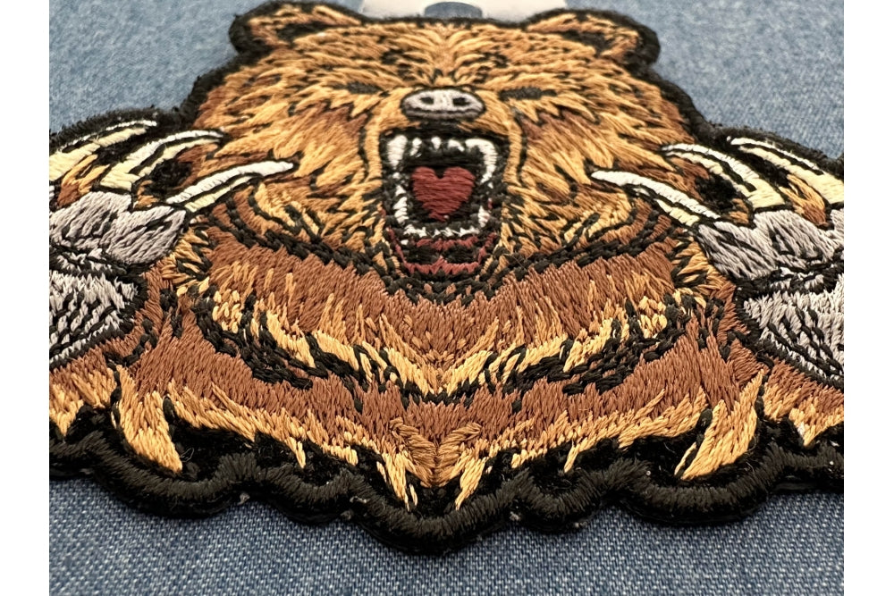 Brown Bear Claws Embroidered Patch shown for scale