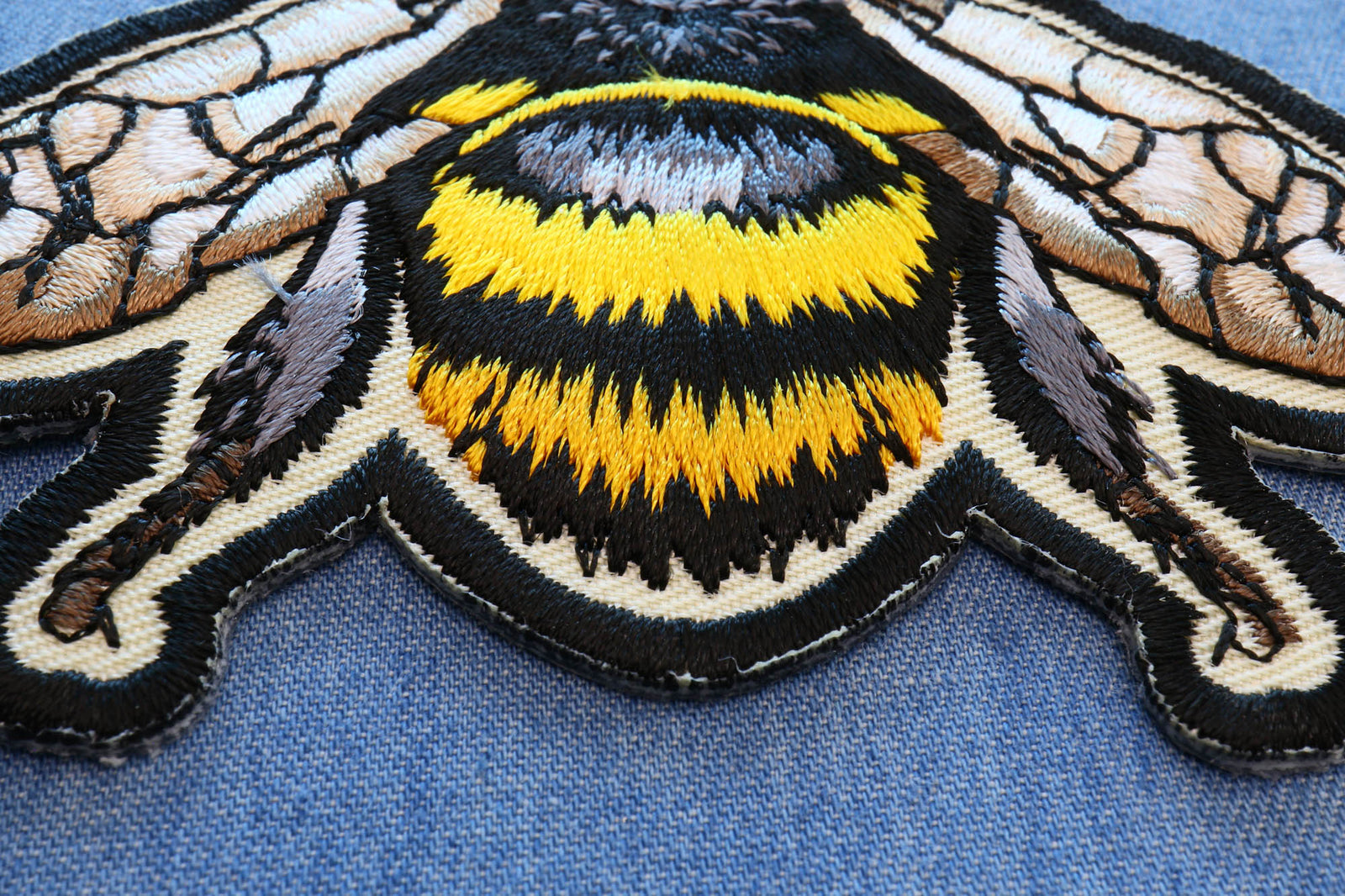 Macro view of the Bee patch abdomen stitching and edge