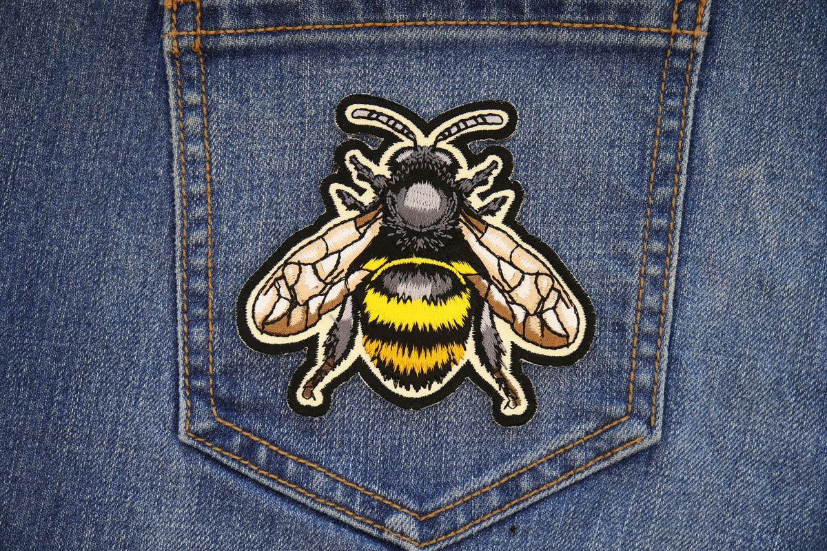 Bee embroidered patch applied to a denim pocket