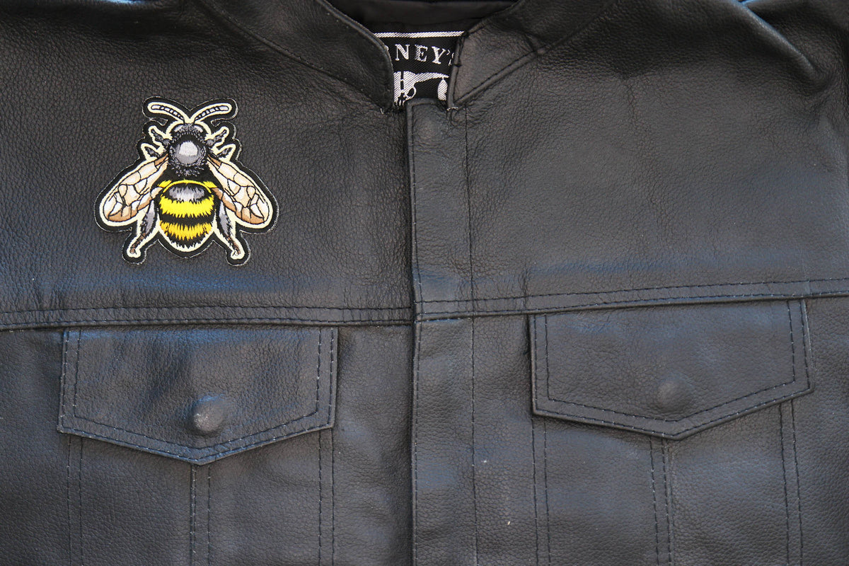 Bee embroidered patch displayed on a black vest