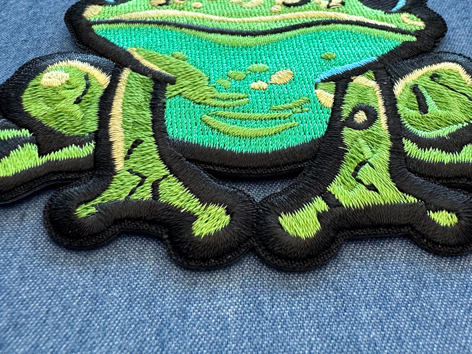 Cute Frog Embroidered Patch shown for scale