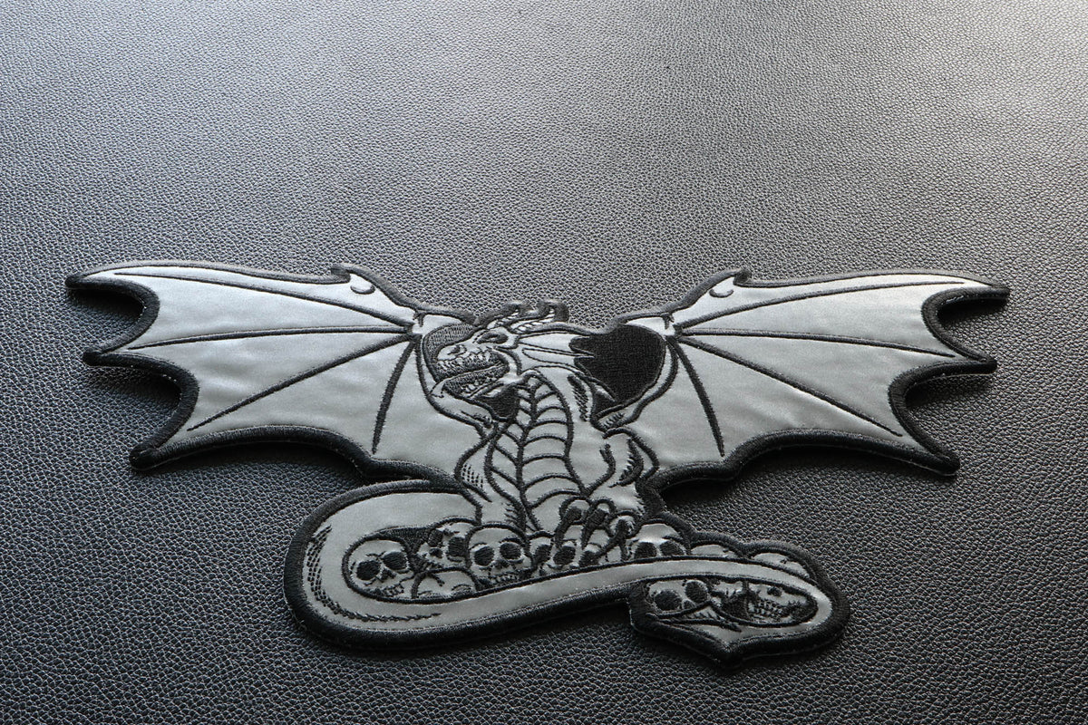 Dragon with Skulls Reflective Embroidered Patch shown for scale