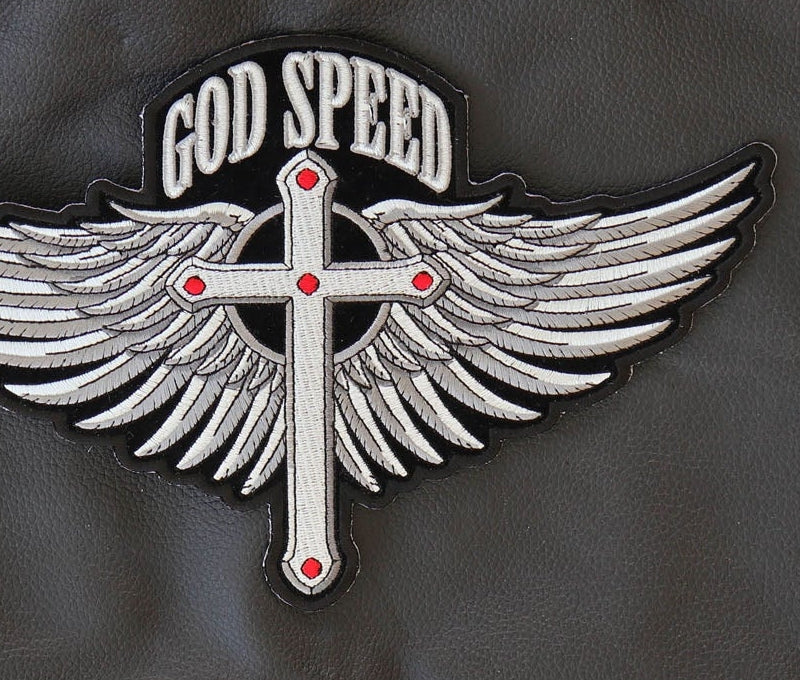 Close-up of God Speed cross and wing feather embroidery