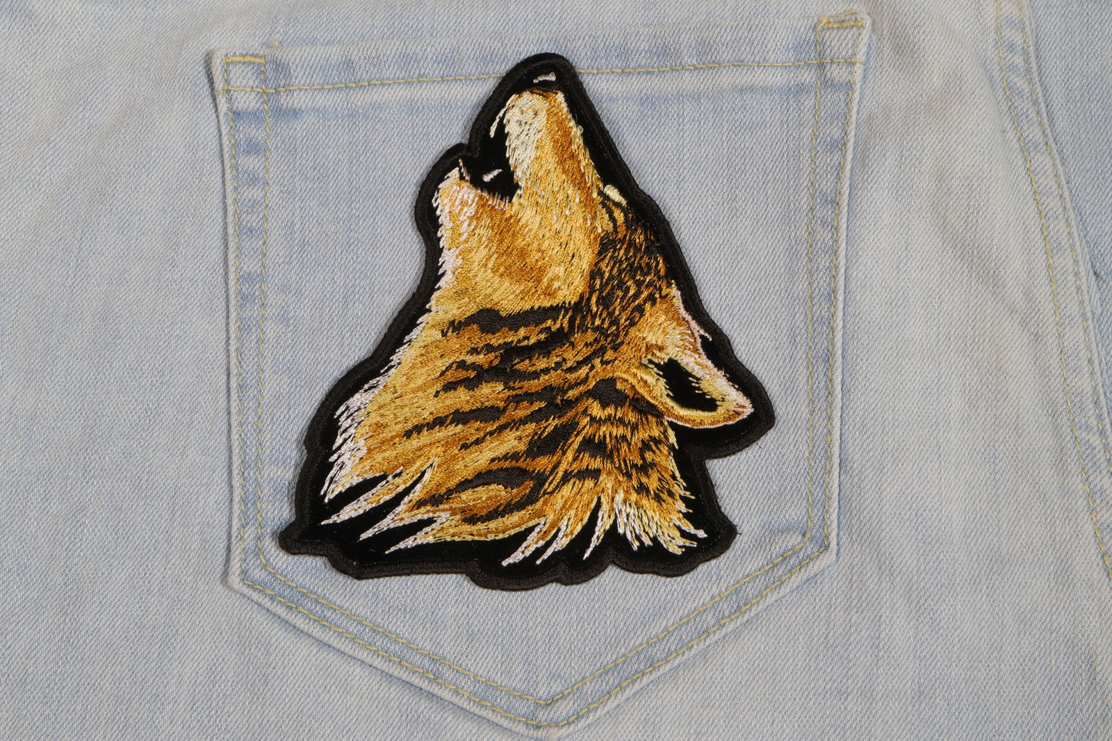 Howling Wolf Embroidered Patch shown for scale