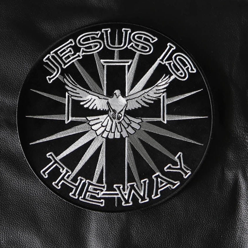 Close-up of Jesus Is the Way lettering, cross and dove embroidery