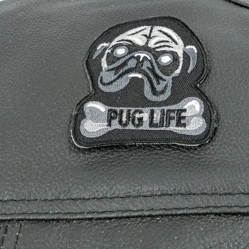 Close-up of Pug Life dog face, bone lettering and embroidered edge
