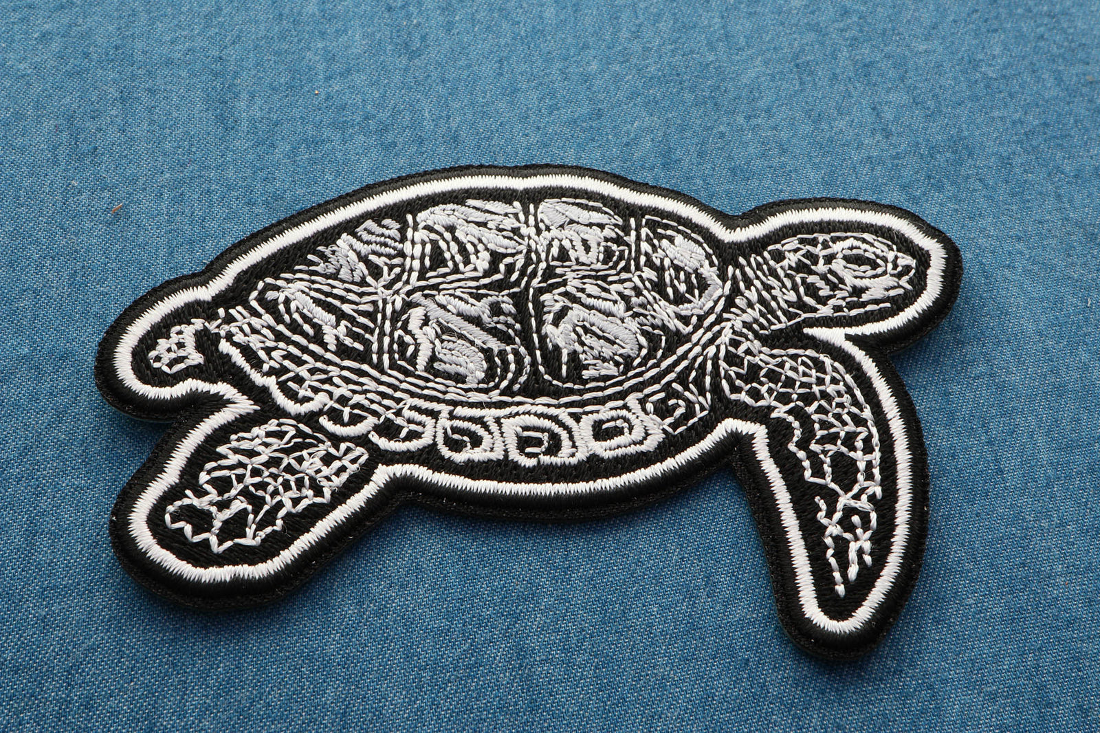 Tribal Turtle Embroidered Patch shown for scale