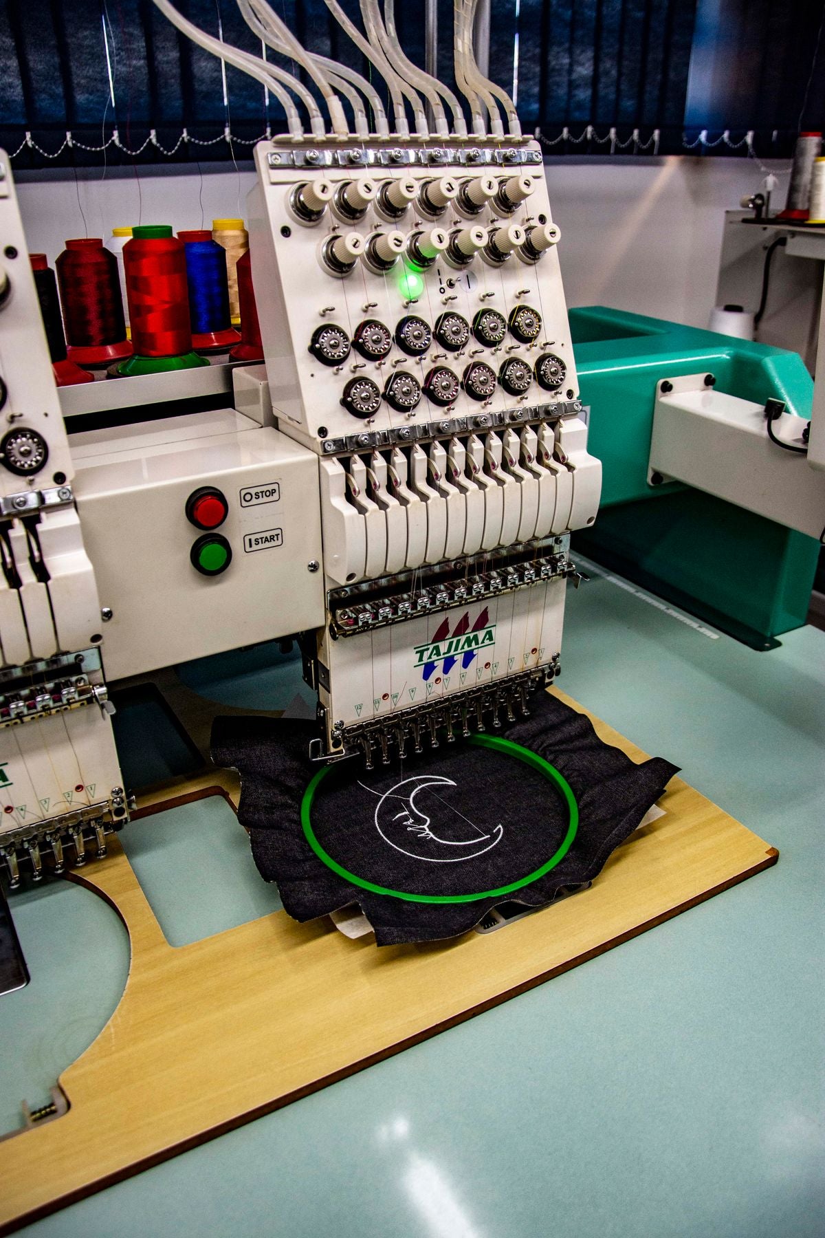 Industrial embroidery machine stitching a design
